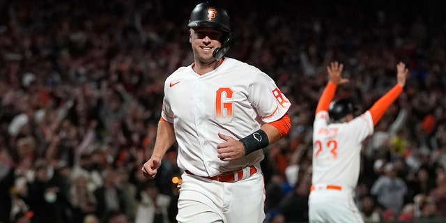 Buster Posey of the San Francisco Giants heads home to score against the Los Angeles Dodgers in the eighth inning of a baseball game in San Francisco on Tuesday, July 27, 2021.