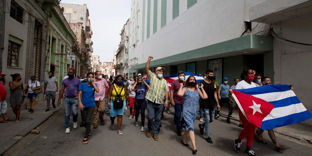 Backers of the government march in Havana, Cuba, Sunday, July 11, 2021. Hundreds of supporters of the government took to the streets while hundreds protested against ongoing food shortages and high prices of foodstuffs. (AP Photo/Ismael Francisco)