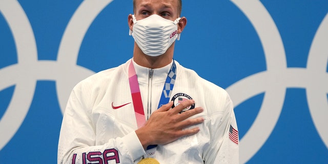 American Caeleb Dressel steps onto the podium after receiving his gold in the men's 100-meter freestyle at the 2020 Summer Olympics on Thursday, July 29, 2021, in Tokyo.  (Associated press)