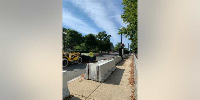 Crews are stacking the perimeter fence in piles and moving the concrete barriers that reinforced the fence. (Kelly Laco/Fox News)