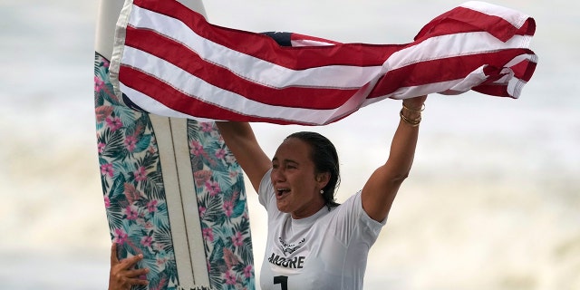 Carissa Moore of the United States celebrates winning the gold medal in the women's surf competition at the 2020 Summer Olympics on Tuesday, July 27, 2021, at Tsurigasaki Beach in Ichinomiya, Japan.  (Associated press)