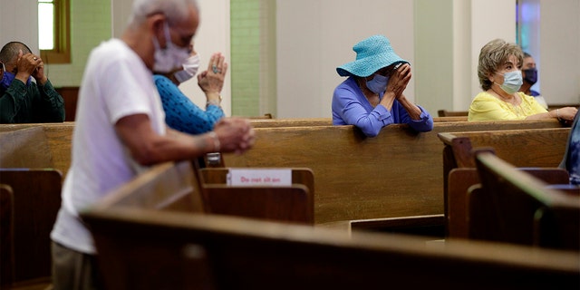 Parishioners wear face masks as they attend an in-person Mass at Christ the King Catholic Church in San Antonio, Texas, Tuesday, May 19, 2020. (AP Photo/Eric Gay, File)