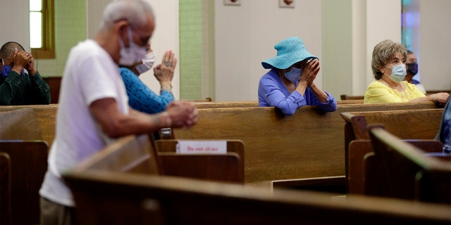 Parishioners wear face masks as they attend an in-person Mass at Christ the King Catholic Church in San Antonio, Texas, Tuesday, May 19, 2020. (AP Photo/Eric Gay, File)