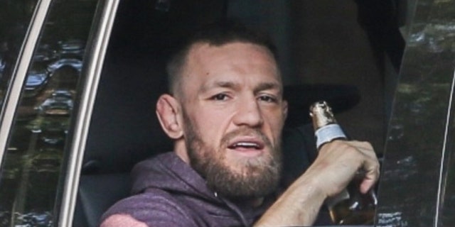McGregor was released on Wednesday on his 33rd birthday.  He is seen here savoring what appears to be a cold Cerveza as he walks back to his hotel.  (BACKGRID USA)