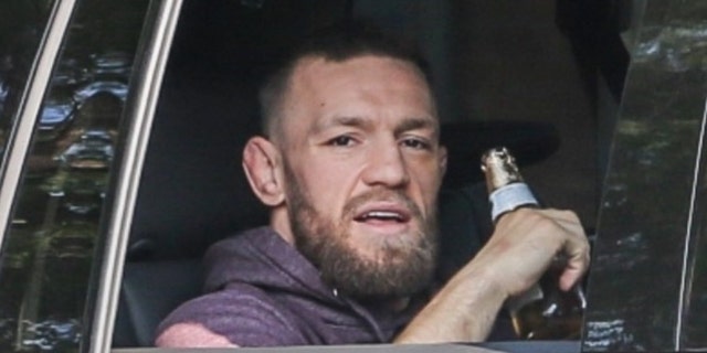 McGregor was released on Wednesday on his 33rd birthday.  He is seen here savoring what appears to be a cold Cerveza as he walks back to his hotel.  (BACKGRID USA)