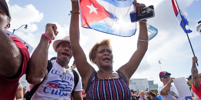 Dulce Diaz and her brother Carlos Diaz demonstrate, July 14, 2021, in Miami's Little Havana neighborhood, as people rallied in support of antigovernment demonstrations in Cuba.