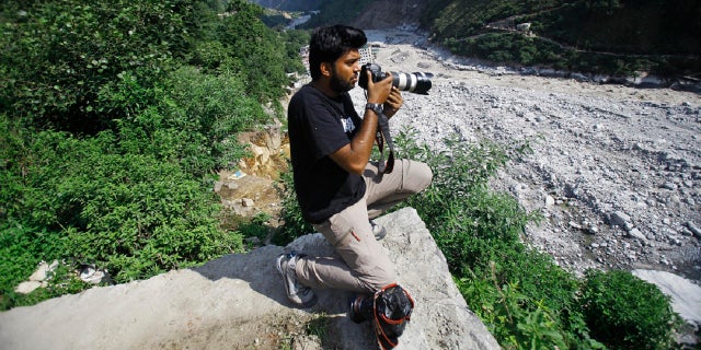 Reuters photographer Danish Siddiqui covers the monsoon floods and landslides in the upper reaches of Govindghat, India, Saturday, June 22, 2013. (AP)