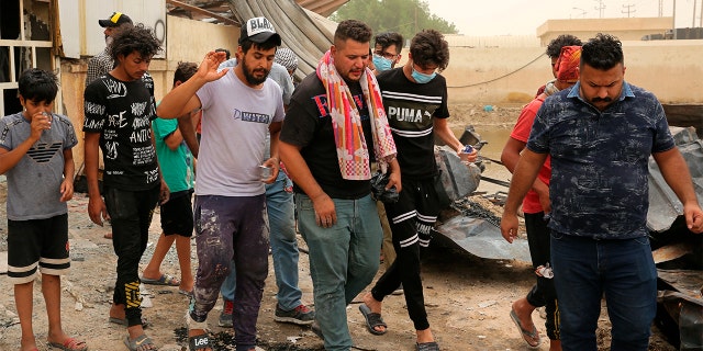 Rescuers and civilians look for bodies after a catastrophic blaze erupted Monday at a coronavirus hospital ward in the al-Hussein Teaching Hospital, in Nasiriyah, Iraq, Tuesday, July 13, 2021.