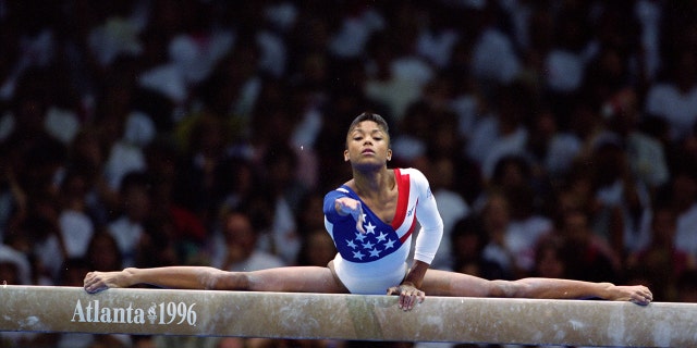 July 23, 1996: Dominic Dawes of America stretches on a balance beam during her routine at the Georgia Dome at the 1996 Olympic Games in Atlanta, Georgia. Mandatory credit: Doug Pensinger / Allsport