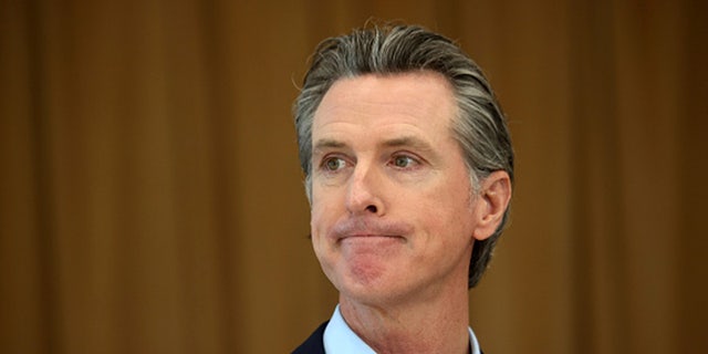 California Gov. Gavin Newsom looks on during a news conference after he toured the newly reopened Ruby Bridges Elementary School on March 16, 2021, in Alameda, California. 