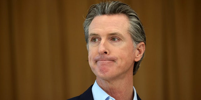 California Gov. Gavin Newsom looks on during a news conference after he toured the newly reopened Ruby Bridges Elementary School on March 16, 2021, in Alameda, California. 