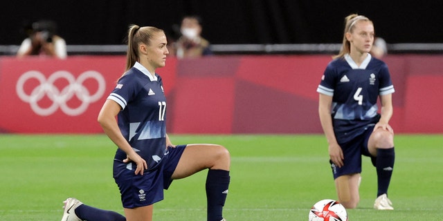 Great Britain striker Georgia Stanway (left) and Great Britain midfielder Keira Walsh kneel ahead of the Tokyo 2020 Olympic Games Women's Group E first round soccer match between Great Britain and Chile at Sapporo Dome in Sapporo on July 21, 2021 (Photo by Asano Ikko / AFP via Getty Images)