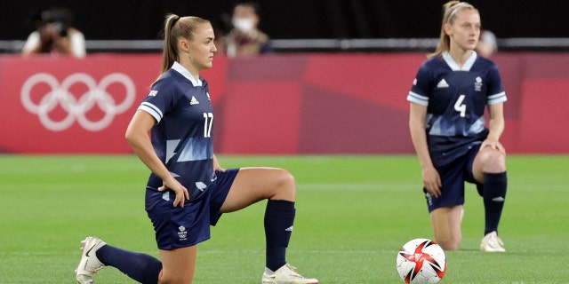 Great Britain striker Georgia Stanway (left) and Great Britain midfielder Keira Walsh kneel ahead of the Tokyo 2020 Olympic Games Women's Group E first round soccer match between Great Britain and Chile at Sapporo Dome in Sapporo on July 21, 2021 (Photo by Asano Ikko / AFP via Getty Images)