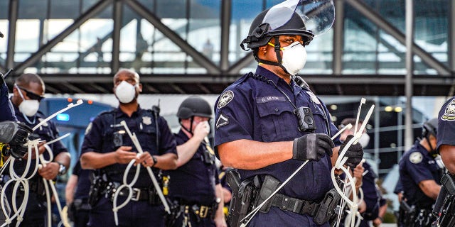 ATLANTA, USA - MAY 29: Police officers stand guard during a protest following the death of George Floyd outside of the CNN Center next to Centennial Olympic Park in downtown Atlanta, Georgia, United States on May 29, 2020. It was announced Friday that Derek Chauvin, the former Minneapolis police officer caught on camera with his knee on Floyd?s neck, has been arrested and charged with third-degree murder and manslaughter. (Photo by Ben Hendren/Anadolu Agency via Getty Images)