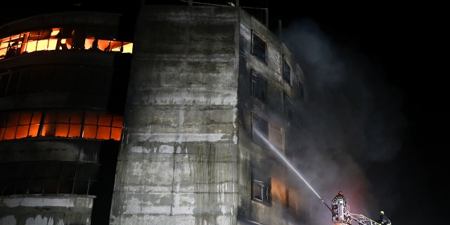 DHAKA, BANGLADESH - 2021/07/09: Firefighters work to put out the blaze at a factory called Hashem Foods Ltd. in Rupganj, in Narayanganj district, on the outskirts of Dhaka. (Photo by Md. Mir Hossen Roney / Pacific Press / LightRocket via Getty Images)