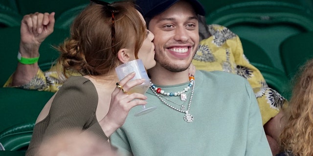 Phoebe Dynevor and Pete Davidson exchange sweet gestures on day 6 of the Wimbledon Tennis Championships at the All England Lawn Tennis and Croquet Club on July 03, 2021 in London. (Photo by Karwai Tang/WireImage)