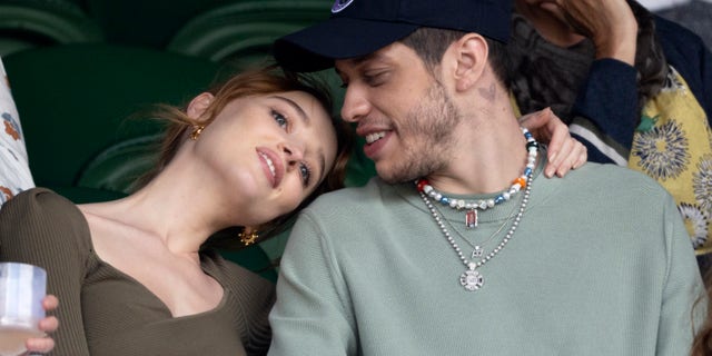 Phoebe Dynevor rests her head on Pete Davidson's shoulder at Wimbledon Tennis Championships at the All England Lawn Tennis and Croquet Club on July 03, 2021 in London. (Photo by Karwai Tang/WireImage)
