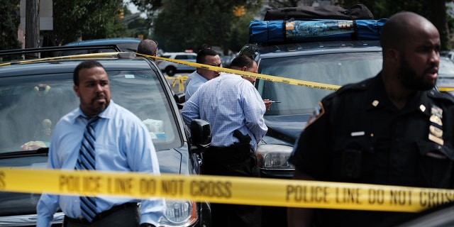 NEW YORK, NEW YORK - JULY 14: Police converge on the scene of a shooting in Brooklyn, one of numerous during the day, on July 14, 2021 in New York City. New York Governor Andrew Cuomo and the Democratic nominee for New York City mayor, Eric Adams, held a joint news conference in Brooklyn today where the two leaders spoke on the rising rates of gun violence across the city. The governor announced that New York State will shortly offer 4,000 summer jobs and full-time jobs with training for youth in high-crime neighborhoods. (Photo by Spencer Platt/Getty Images)