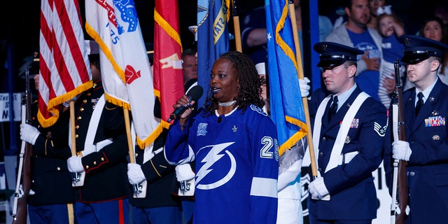 U.S. Air Force veteran Sonya Bryson-Kirksey is seen in 2018 singing the national anthem before an NHL playoff game between the Tampa Bay Lightning and the New Jersey Devils in Tampa, Florida.  (Getty Images)
