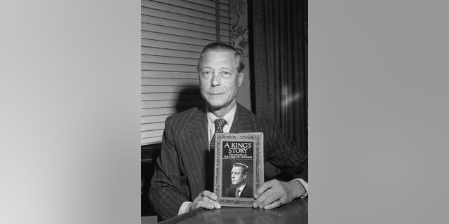The Duke of Windsor (1894 - 1972), formerly King Edward VIII, with his memoirs, entitled 'A King's Story: The Memoirs of the Duke of Windsor', circa 1951.