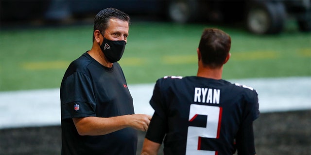 SEPTEMBER 27: Matt Ryan #2 of the Atlanta Falcons speaks with quarterbacks coach Greg Knapp prior to an NFL game against the Chicago Bears at Mercedes-Benz Stadium on September 27, 2020 in Atlanta, Georgia. (Photo by Todd Kirkland/Getty Images)