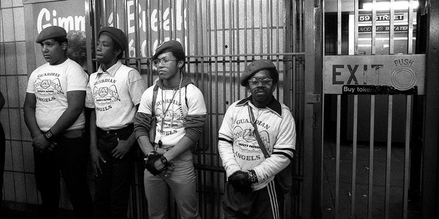 Portrait of four members of the Guardian Angels standing in a subway station, New York, New York, mid-1980s.