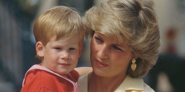 Princess Diana wears yellow blouse while holding Prince Harry as a toddler