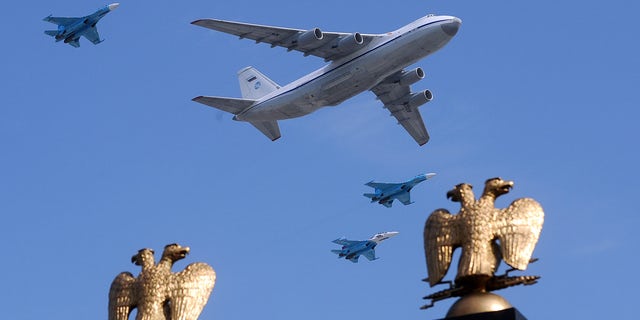 A Russian Il-80 plane and MiG-29 fighter jets fly over Red Square during the Victory Day parade in Moscow on May 9, 2010. 