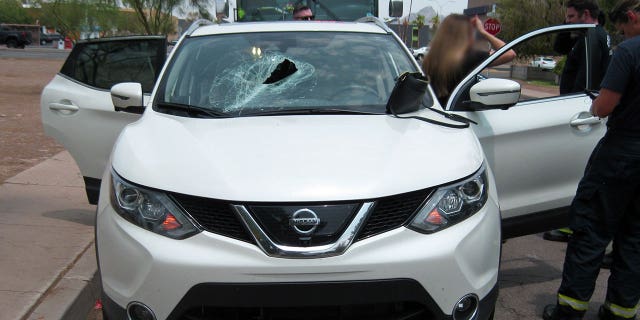 Driver Mandy Poff's vehicle is seen after Thursday's highway mishap, in which a metal pole from a passing truck crashed through her vehicle's windshield. The truck driver hasn't yet been located, authorities say. (Arizona Department of Public Safety)