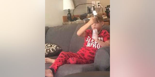 An image shows Joshua "JJ" Vallow sitting on a couch. The photo was released with thousands of emails by authorities and is the last known image of him before he disappeared.