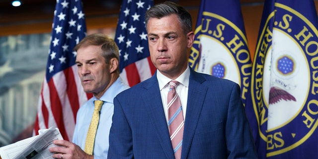 Rep. Jim Banks, R-Ind., center, and Rep. Jim Jordan, R-Ohio, left, exchange places at the podium during a news conference after House Speaker Nancy Pelosi rejected the two who were picked by House Minority Leader Kevin McCarthy, R-Calif., for the committee investigating the Jan. 6 Capitol insurrection at the Capitol in Washington, Wednesday, July 21, 2021.