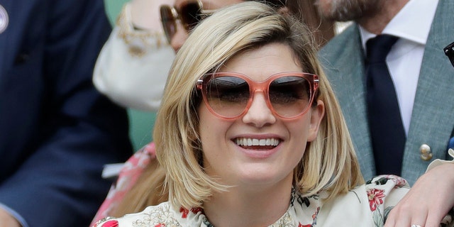 In this file photo dated Saturday, July 13, 2019, actress Jodie Whittaker sits in the royal box on center court to watch the final women's singles match between American Serena Williams and Romania's Simona Halep during the Twelfth day of the Wimbledon tennis championships in London.  The BBC announced Thursday, July 29, 2021 that star Jodie Whittaker will be leaving the sci-fi series Doctor Who next year, but before leaving Whittaker will appear in a new six-episode series in 2021 and three special episodes in 2022.