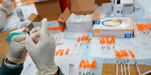 A nurse fills a syringe with the Johnson &;  Johnson COVID-19 vaccine at a pop-up vaccination site in the Staten Island borough of New York City. 