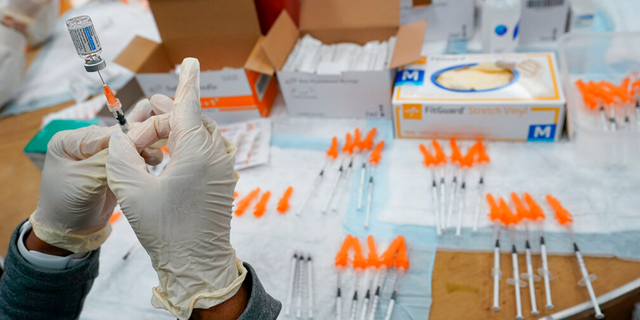 A registered nurse fills a syringe with the Johnson &amp; Johnson COVID-19 vaccine at a pop up vaccination site in the Staten Island borough of New York. 