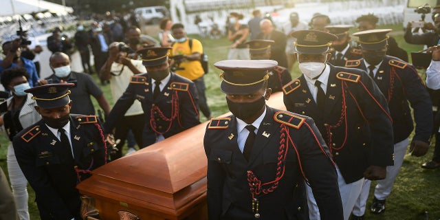 Police carry the coffin of slain Haitian President Jovenel Moise at the start of the funeral on Friday.