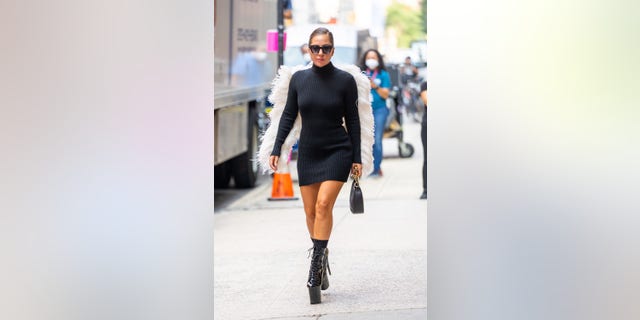The ‘A Star Is Born’ actress wore a little black dress paired with black platform heels and white angel wings.