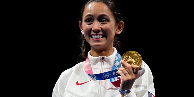 Gold medalist Lee Kiefer of the United States, holds her gold medal during the medal ceremony for the women's individual Foil final competition at the 2020 Summer Olympics, Sunday, July 25, 2021, in Chiba, Japan. (Associated Press)