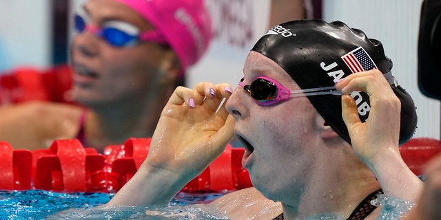 Lydia Jacoby of the United States sees the results after winning the final of the women's 100-meter breaststroke at the 2020 Summer Olympics, Tuesday, July 27, 2021, in Tokyo, Japan. (AP Photo/Martin Meissner)