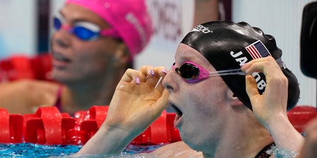 Lydia Jacoby of the United States sees the results after winning the final of the women's 100-meter breaststroke at the 2020 Summer Olympics, Tuesday, July 27, 2021, in Tokyo, Japan. (AP Photo/Martin Meissner)