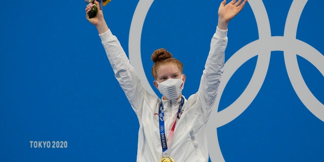 Lydia Jacoby of the United States poses with the gold medal after winning the final of the women's 100-meter breaststroke at the 2020 Summer Olympics, Tuesday, July 27, 2021, in Tokyo, Japan. (AP Photo/Petr David Josek)