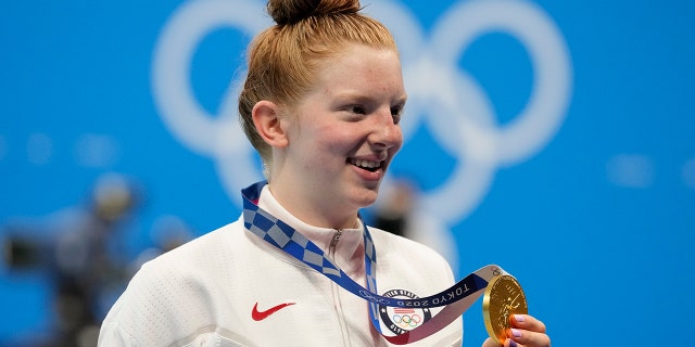 Lydia Jacoby of the United States poses with the gold medal after winning the women's 100-meter breaststroke final at the 2020 Summer Olympics on Tuesday, July 27, 2021, in Tokyo.  (Associated press)