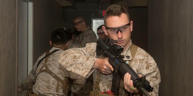 U.S. Marines attached to the Marine Security Augment Unit (MSAU) simulate room clearing through a Tactical Maze in Summit Point, W.Va., April 9, 2015. The training prepares members of MSAU for the protection and security of American Embassies and assets across the globe. (U.S. Marine Corps photo by Cpl. Daniel Benedict/Released)