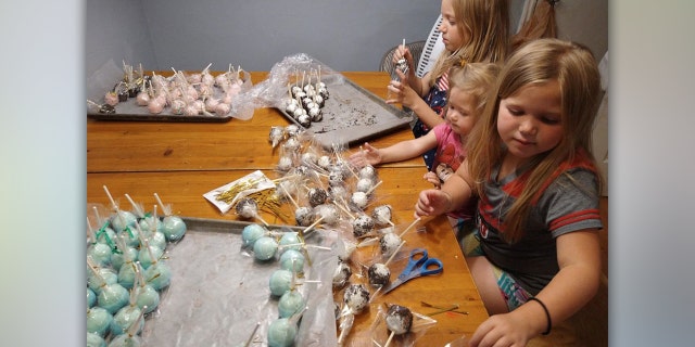 Madsen's daughters' preparing cake pops for the lemonade stand.