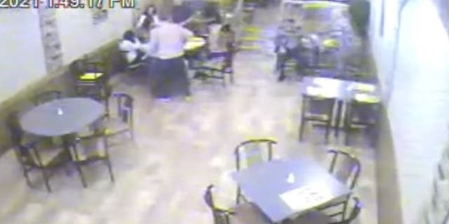 Surveillance video inside a café shows Manchester police Det. Richard Jupinka rushing to help save a 10-year-old who was choking.