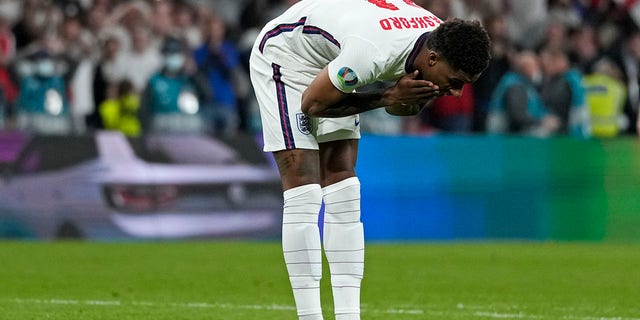 England's Marcus Rashford reacts after he missed to score during the penalty shootout of the Euro 2020 soccer championship final between England and Italy at Wembley stadium in London, Sunday, July 11, 2021. (AP Photo/Frank Augstein, Pool)