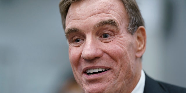 Sen. Mark Warner, D-Va., speaks with reporters as he boards the Senate subway, at the Capitol in Washington. (AP Photo/J. Scott Applewhite)