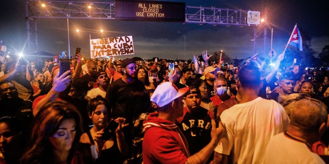 People block Palmetto Expressway during a protest showing support for Cubans demonstrating against their government, in Miami, on July 13, 2021. - One person died and more than 100 others, including independent journalists and dissidents, have been arrested after unprecedented anti-government protests in Cuba, with some remaining in custody on Tuesday, observers and activists said. (Photo by EVA MARIE UZCATEGUI/AFP via Getty Images)