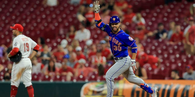 The New York Mets' Michael Conforto gestures after hitting a solo home run during the 11th inning of a game against the Cincinnati Reds in Cincinnati July 19, 2021.