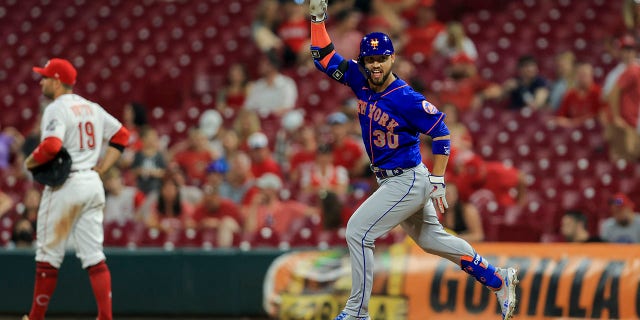 The New York Mets' Michael Conforto gestures after hitting a solo home run during the 11th inning of a game against the Cincinnati Reds in Cincinnati July 19, 2021.