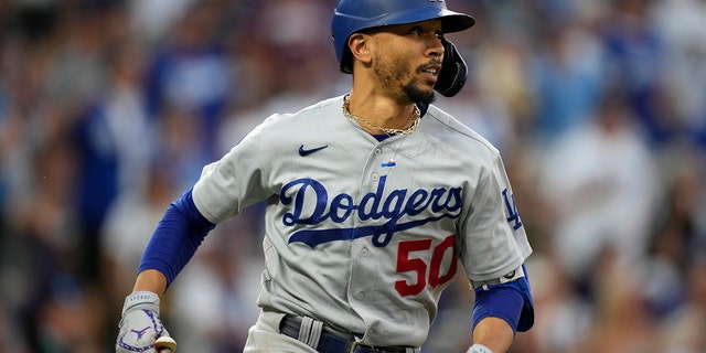 Los Angeles Dodgers' Mookie Betts sees a double against Colorado Rockies reliever Mychal Givens in the seventh inning of a baseball game in Denver, Saturday, July 17, 2021.